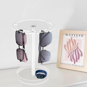 Macro shot of acrylic sunglass stand with watch storage on the circular base