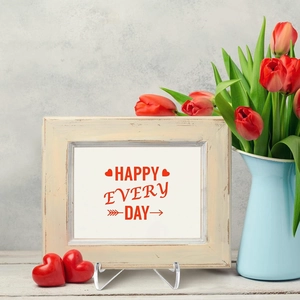 Vintage white wooden photo frame with transparent acrylic stand and red tulips