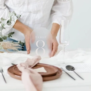 Frosted arch acrylic table number 8 held by hands for minimalist wedding table decor