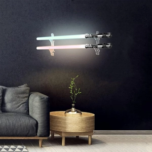 Dual wall-mounted clear acrylic lightsaber display rack showing two glowing lightsabers