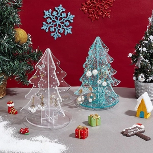 Macro view of Christmas tree acrylic earring display stand with various festive earrings
