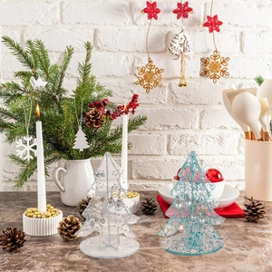 Detail view of a Christmas tree shaped acrylic earring holder with glitter blue finish