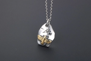 Detailed close-up of retro two-tone eagle shield pendant with star pattern and chain