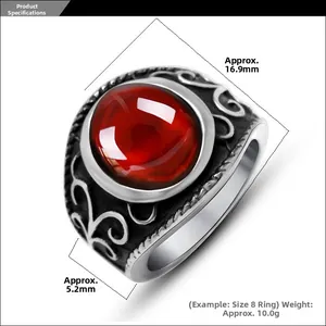 Macro shot of men's vintage steel ring with a large red stone and intricate relief