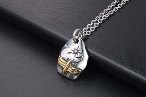 Macro detail of retro eagle pendant featuring hammered silver texture and sunburst carving