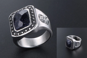 Detail of vintage ring with blue sandstone inlay and embossed fleur-de-lis patterns