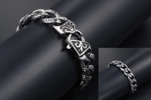 Close-up of vintage stainless steel leopard link bracelet with intricate engraved clasp