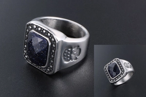 Macro shot of blue sandstone ring with skull engravings on a vintage steel band