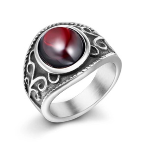 Vintage stainless steel ring featuring a round deep red garnet stone and embossed scrolls