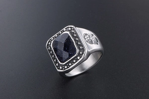 Macro view of vintage men's ring with rectangle blue sand stone and skull relief detail
