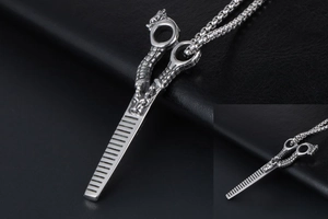 Macro shot of silver dragon-carved thinning scissors pendant with stainless steel bead chain