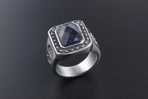 Macro shot of retro silver ring with square blue sandstone inlay and carved details