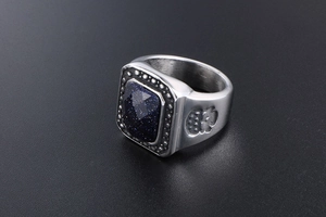 Macro shot of vintage silver ring featuring square blue sandstone and embossed patterns