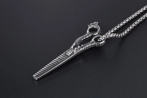 Macro detail of silver dragon-themed hair comb pendant with intricate scales and box chain