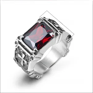 Detail view of gothic steel ring with red stone and embossed Maltese cross patterns