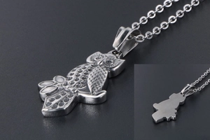 Macro detail of silver owl pendant showing fine feather textures and smooth back structure