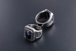 Close-up of vintage square men's rings with blue sandstone and embossed side patterns