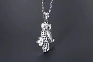 Detailed close-up of retro owl pendant necklace with vintage polished finish details