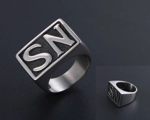 Macro detail of men's silver steel signet ring with SN letter engraving and brushed finish