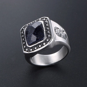 Vintage rock men's ring with blue sandstone center and skull relief carvings