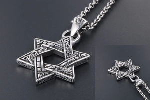Detailed view of vintage silver hexagram pendant with intricate Celtic knot patterns