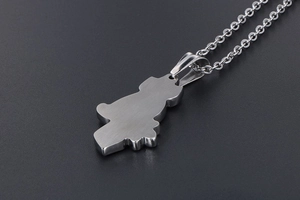 Macro shot of silver stainless steel girl pendant with brushed metal back finish