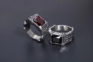 Macro detail of gothic signet rings with ruby and onyx stones and cross carvings