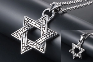 Macro detail of vintage silver hexagram pendant with antique floral relief patterns