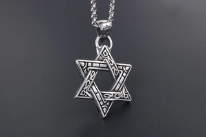 Detail view of retro silver hexagram pendant with intricate vine engravings and ring chain