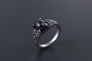 Detailed macro view of vintage flower stainless steel ring with oval blue sandstone
