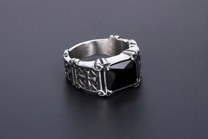 Macro detail of gothic signet ring with black gemstone and engraved side crosses