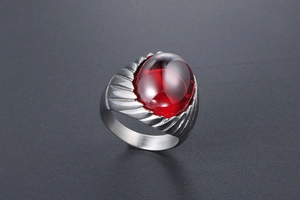 Detailed side view of a vintage men's steel ring with a large oval red agate stone inlay