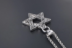 Macro shot of vintage titanium steel hexagram pendant with intricate Celtic relief carving