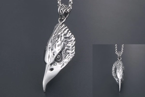 Detailed view of eagle head pendant showing realistic feather texture and relief work