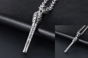 Macro detail of silver matchstick pendant with engraved Chinese characters and thick chain