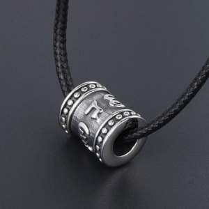 Vintage stainless steel cylinder pendant with embossed mantra on black woven cord