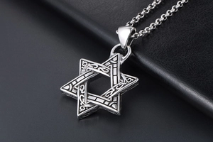 Macro shot of retro stainless steel hexagram pendant with intricate Celtic patterns