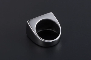 Detailed close-up of a silver titanium steel signet ring with a polished rectangular top