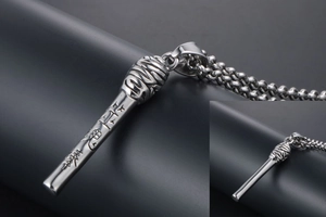 Macro shot of silver titanium steel cylinder pendant with engraved Chinese characters