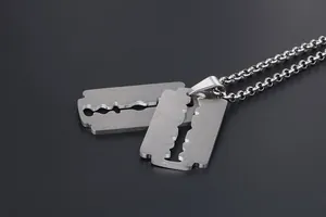 Close-up of double razor blade pendants in brushed stainless steel with an O-ring chain