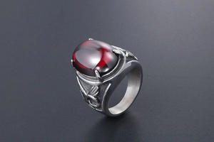 Macro detail of men's eagle ring featuring red oval agate and gothic wing engravings