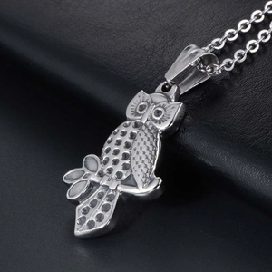 Men's owl pendant necklace in silver stainless steel on black leather background
