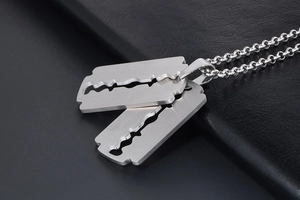 Close-up of double razor blade pendant in polished stainless steel on a bead chain