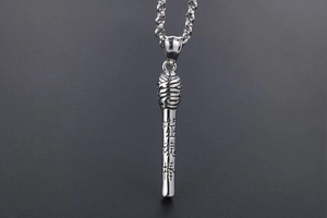 Close-up of silver steel stick pendant with engraved Chinese characters and texture