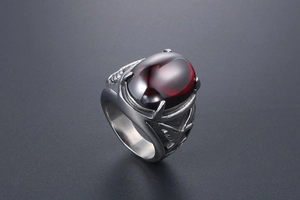 Macro shot of vintage titanium steel ring with eagle relief and oval red agate stone