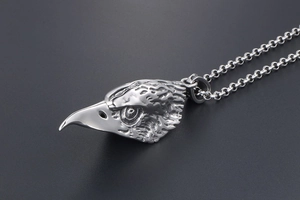 Detailed macro view of retro stainless steel eagle head pendant with feathered texture