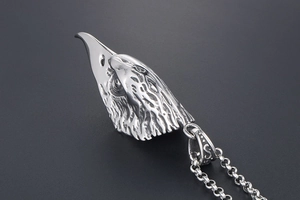 Macro shot of retro stainless steel eagle head pendant with detailed feather textures