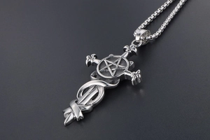 Macro detail of gothic pentagram sword pendant in polished vintage stainless steel
