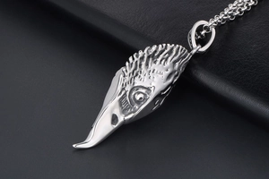Macro view of vintage silver eagle head pendant with realistic feather details