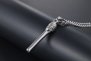 Macro view of polished silver microphone pendant necklace with fine bead chain detail